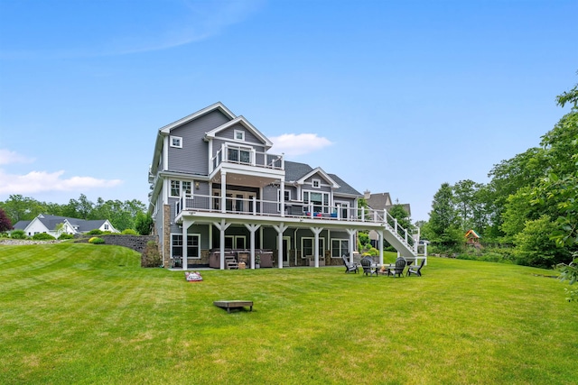 74 Childs Dr, Dover, NH 03820 - back of house featuring a hot tub, a balcony, stairway, and a lawn