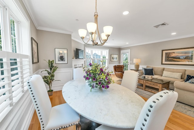 61 Acadia Ln Unit 309, Exeter, NH 03833 - dining space featuring light wood-type flooring, a chandelier, crown molding, wainscoting, and recessed lighting