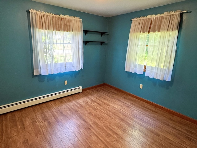 257 Crane St, Littleton, NH 03561 - empty room featuring a baseboard heating unit and wood finished floors