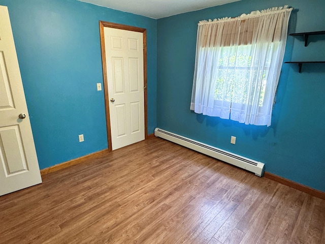 257 Crane St, Littleton, NH 03561 - spare room with a baseboard radiator and wood finished floors