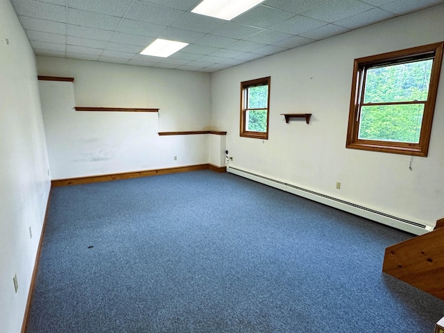 257 Crane St, Littleton, NH 03561 - empty room featuring a baseboard heating unit, dark carpet, and a drop ceiling