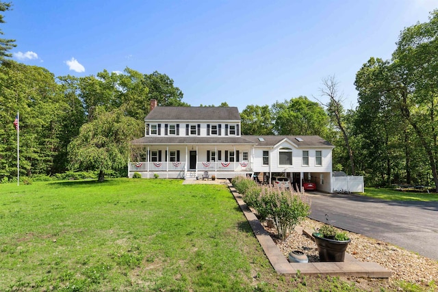 11 Parkside Dr, Pelham, NH 03076 - view of front of property featuring a porch, asphalt driveway, a front lawn, a chimney, and a carport