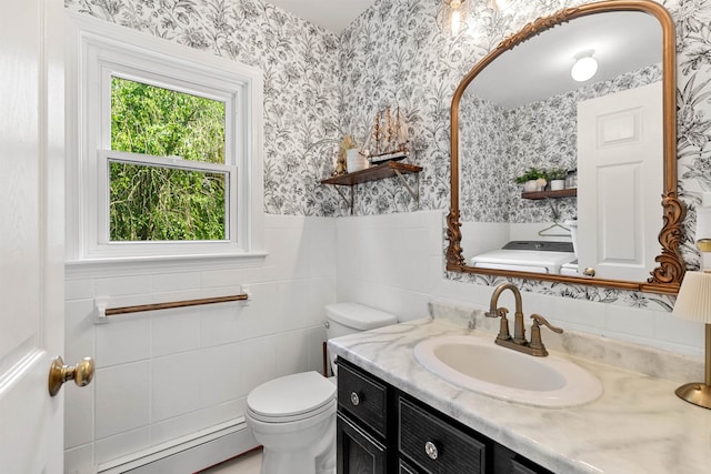 11 Parkside Dr, Pelham, NH 03076 - bathroom with baseboard heating, wallpapered walls, vanity, wainscoting, and tile walls