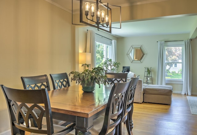 67 Pine Ave, Keene, NH 03431 - dining space with light wood-style flooring, a chandelier, and ornamental molding