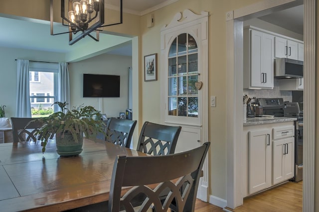 67 Pine Ave, Keene, NH 03431 - dining room with a chandelier, light wood-style flooring, and crown molding