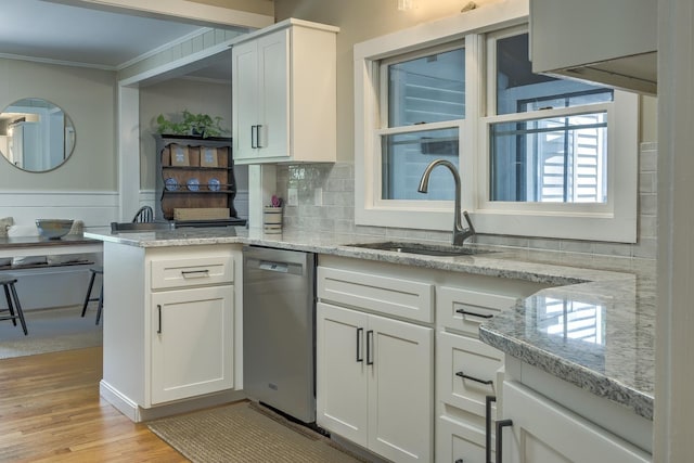 67 Pine Ave, Keene, NH 03431 - kitchen with stainless steel dishwasher, crown molding, white cabinets, light wood-style flooring, and light stone countertops