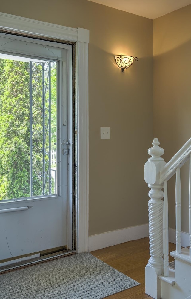 67 Pine Ave, Keene, NH 03431 - foyer entrance with wood finished floors, plenty of natural light, and stairs
