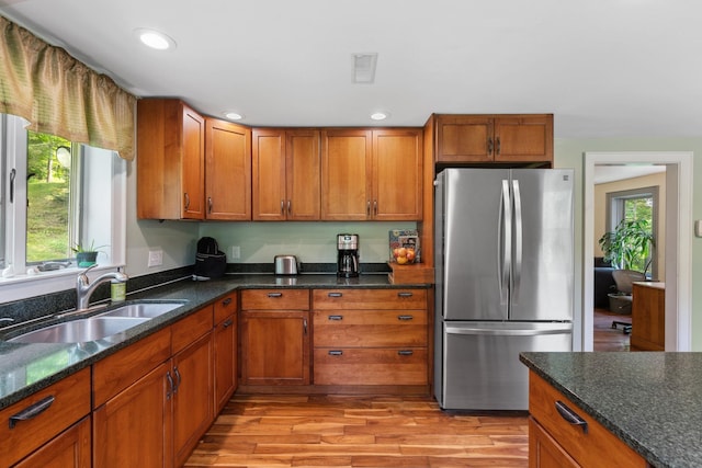 450 Ryan Rd, Duxbury, VT 05676 - kitchen with freestanding refrigerator, healthy amount of natural light, brown cabinets, and recessed lighting