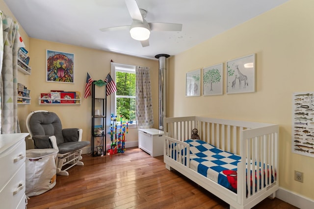 450 Ryan Rd, Duxbury, VT 05676 - bedroom with hardwood / wood-style floors, a crib, and a ceiling fan