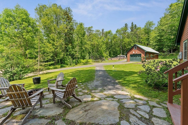 450 Ryan Rd, Duxbury, VT 05676 - view of patio featuring a fire pit, an outdoor structure, and a detached garage