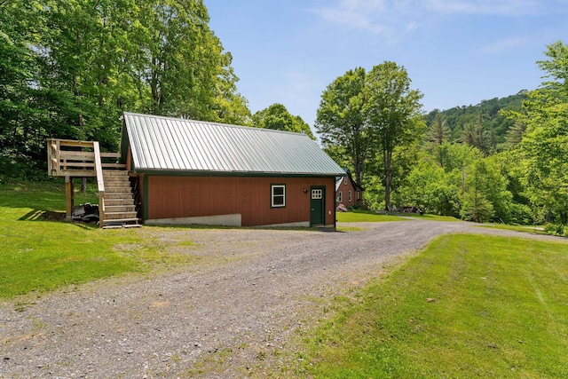 450 Ryan Rd, Duxbury, VT 05676 - garage featuring driveway and a view of trees