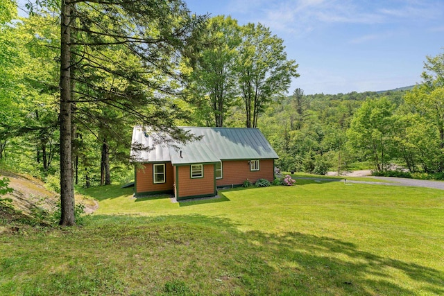 450 Ryan Rd, Duxbury, VT 05676 - view of side of home with a yard, a view of trees, and a metal roof