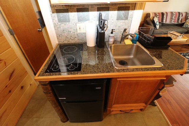 79 Huckleberry Ln Unit 19, Warren, VT 05674 - kitchen featuring tile countertops, light tile patterned floors, black electric stovetop, brown cabinetry, and backsplash