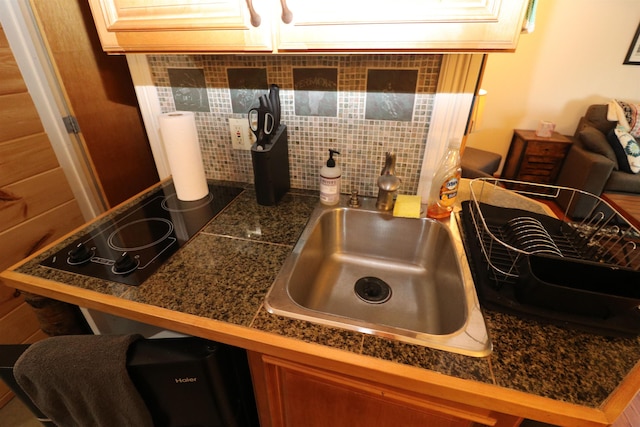 79 Huckleberry Ln Unit 19, Warren, VT 05674 - kitchen view of tile countertops, tasteful backsplash, black electric stovetop, and a kitchen breakfast bar