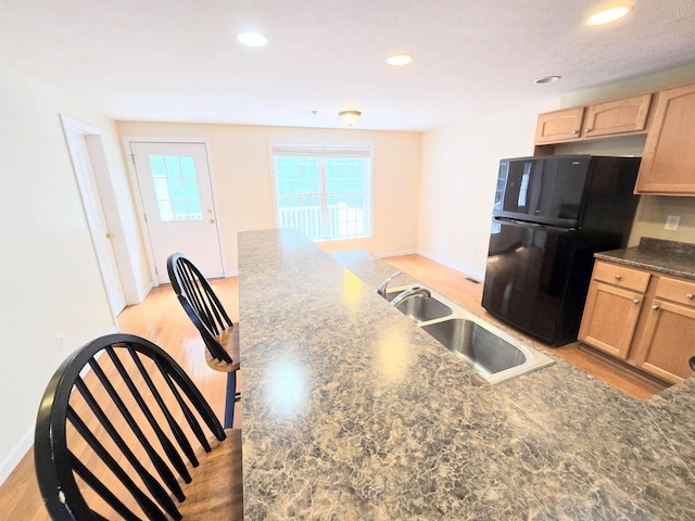 69 Mulberry St Unit 3, Concord, NH 03301 - kitchen with freestanding refrigerator, light brown cabinets, dark countertops, light wood-style floors, and recessed lighting