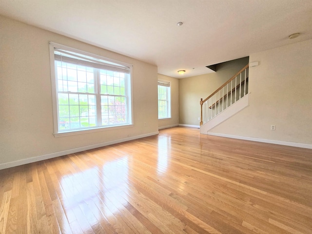 69 Mulberry St Unit 3, Concord, NH 03301 - unfurnished living room featuring light wood-style flooring and stairs