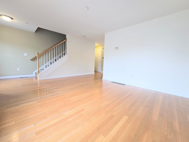 69 Mulberry St Unit 3, Concord, NH 03301 - unfurnished living room featuring stairs and light wood-style flooring