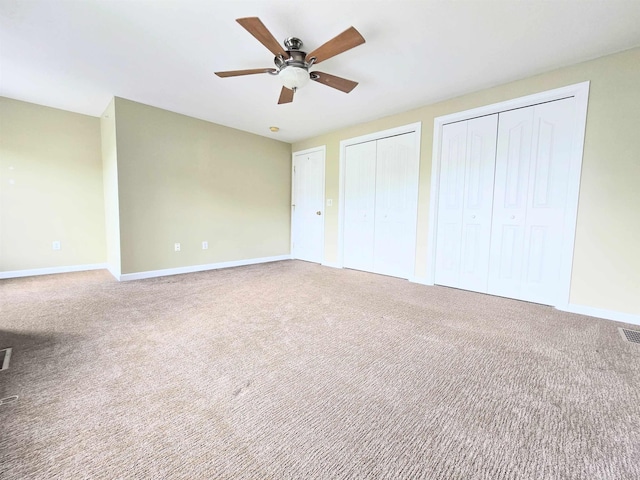 69 Mulberry St Unit 3, Concord, NH 03301 - unfurnished bedroom with multiple closets, carpet, and ceiling fan