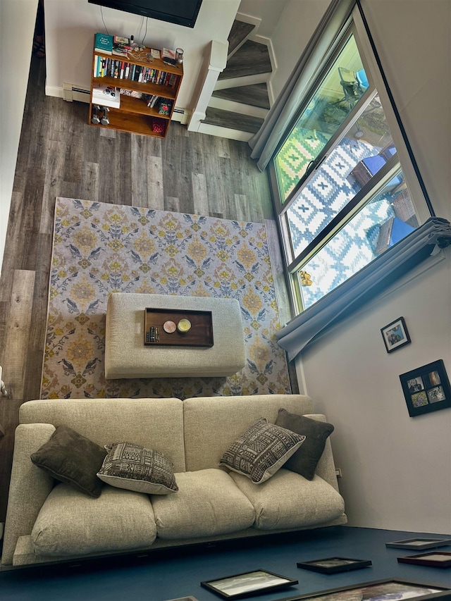 68 Franklin Hts, Rochester, NH 03867 - living area featuring wood finished floors, baseboard heating, and stairway