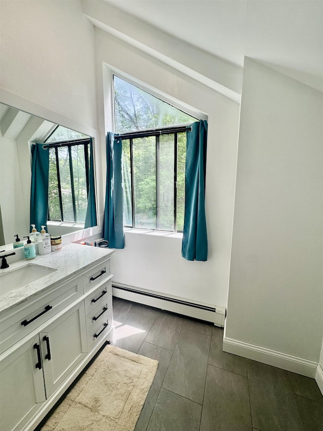 68 Franklin Hts, Rochester, NH 03867 - bathroom featuring a baseboard heating unit, vanity, and healthy amount of natural light