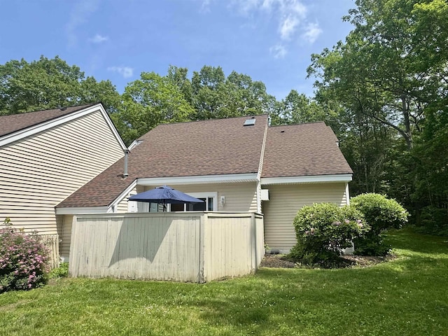 68 Franklin Hts, Rochester, NH 03867 - back of house with a lawn and a shingled roof