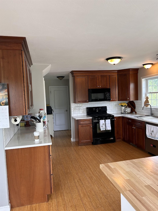 81 Cider St, Epping, NH 03042 - kitchen with black appliances, light countertops, and backsplash