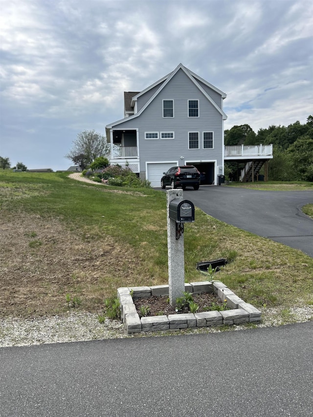 81 Cider St, Epping, NH 03042 - view of property exterior with a garage, a lawn, and asphalt driveway