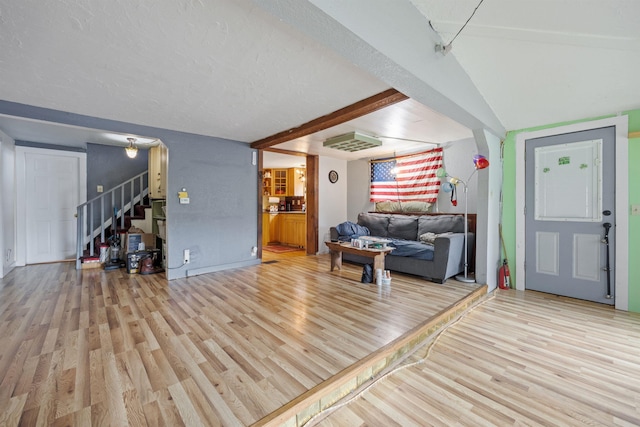 236 N Main St, Franklin, NH 03235 - living room with light wood-type flooring, stairs, and beam ceiling
