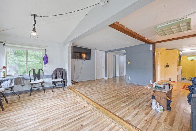 236 N Main St, Franklin, NH 03235 - living area with wood finished floors, arched walkways, and vaulted ceiling