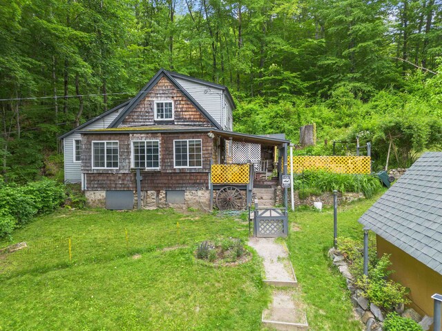 236 N Main St, Franklin, NH 03235 - view of front of property featuring a front lawn and a wooded view