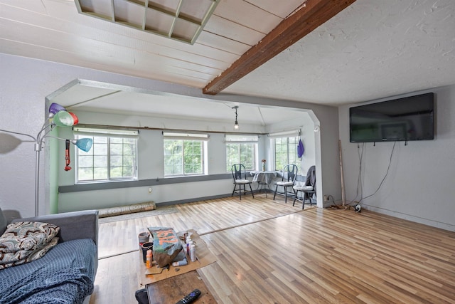 236 N Main St, Franklin, NH 03235 - living area with wood finished floors and beamed ceiling
