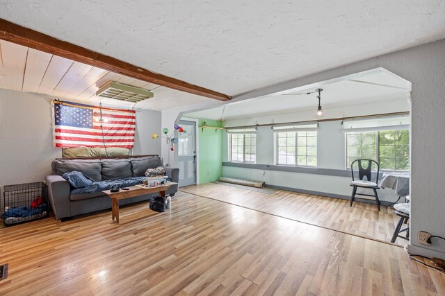 236 N Main St, Franklin, NH 03235 - living room with beamed ceiling, wood finished floors, and a textured wall
