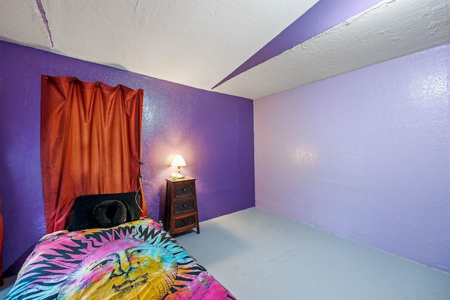 236 N Main St, Franklin, NH 03235 - bedroom featuring a textured wall and concrete floors