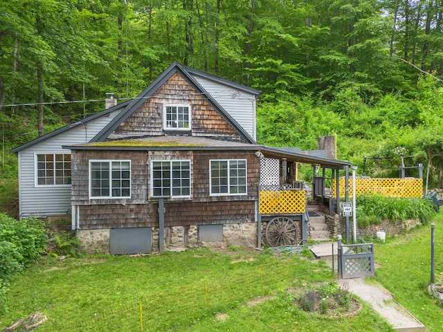 236 N Main St, Franklin, NH 03235 - back of house with a wooded view, a chimney, and a gate