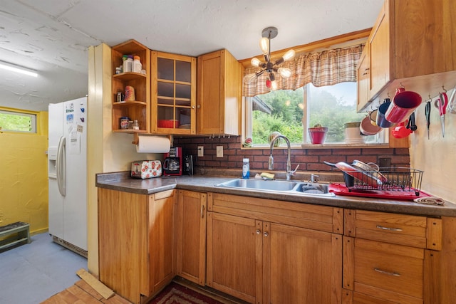 236 N Main St, Franklin, NH 03235 - kitchen with white fridge with ice dispenser, dark countertops, glass insert cabinets, and brown cabinets