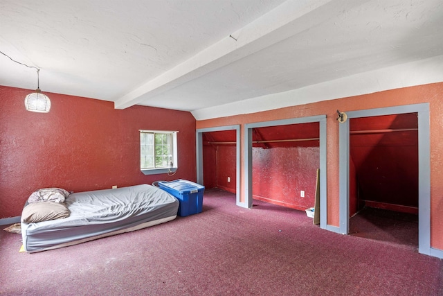236 N Main St, Franklin, NH 03235 - carpeted bedroom featuring beam ceiling, a textured wall, and two closets