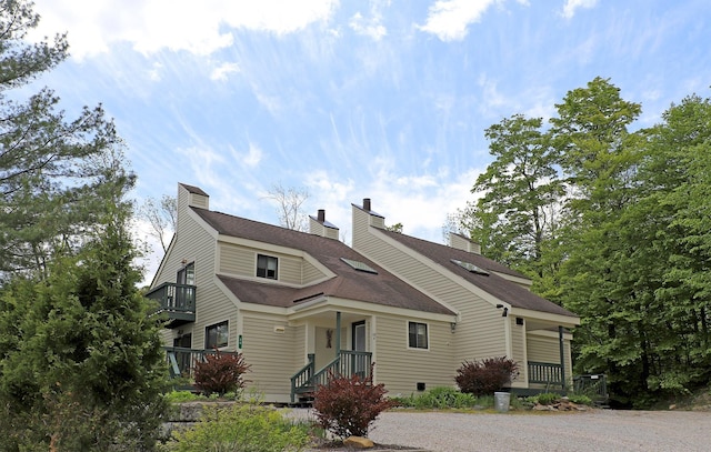 36 Lower Iv Unit 48A, Ludlow, VT 05149 - view of front of property featuring a shingled roof, a balcony, and a chimney
