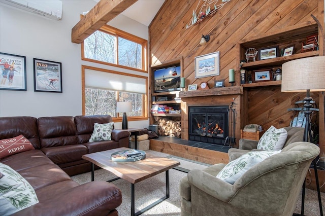 36 Lower Iv Unit 48A, Ludlow, VT 05149 - living area featuring a wall mounted air conditioner, a glass covered fireplace, wood walls, and a high ceiling