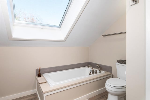 36 Lower Iv Unit 48A, Ludlow, VT 05149 - bathroom with wood finished floors, a bath, vaulted ceiling, and a skylight
