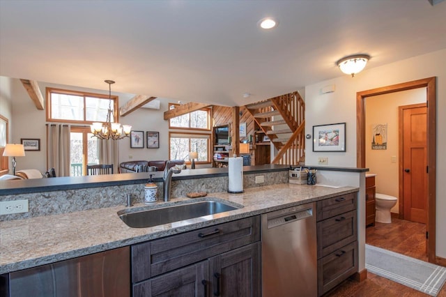36 Lower Iv Unit 48A, Ludlow, VT 05149 - kitchen with stainless steel dishwasher, dark wood finished floors, decorative light fixtures, open floor plan, and a chandelier