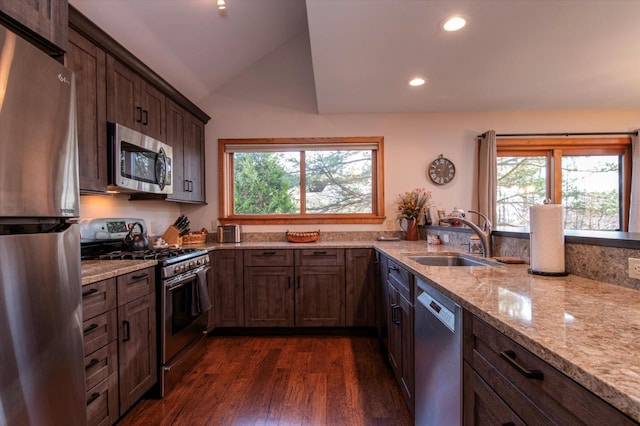 36 Lower Iv Unit 48A, Ludlow, VT 05149 - kitchen with stainless steel appliances, healthy amount of natural light, lofted ceiling, light stone countertops, and dark wood-type flooring