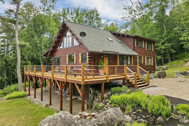 203 Orris Rd, Thornton, NH 03285 - back of house featuring log siding, a deck, and roof with shingles