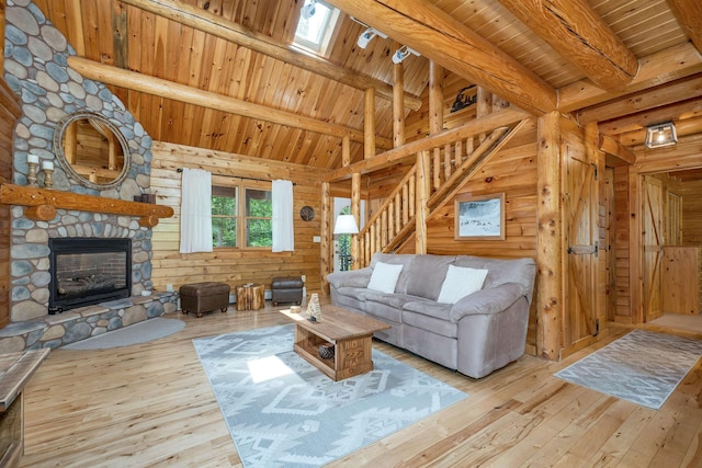 203 Orris Rd, Thornton, NH 03285 - living area with hardwood / wood-style flooring, wood ceiling, a fireplace, wooden walls, and stairway