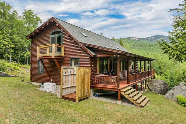 203 Orris Rd, Thornton, NH 03285 - rear view of house with log exterior, a lawn, a deck with mountain view, and a shingled roof