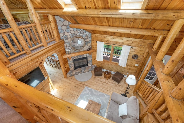 203 Orris Rd, Thornton, NH 03285 - living area featuring wooden ceiling, log walls, wood finished floors, and a fireplace