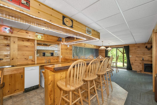 203 Orris Rd, Thornton, NH 03285 - kitchen featuring dishwasher, wooden walls, a drop ceiling, a breakfast bar, and a kitchen island