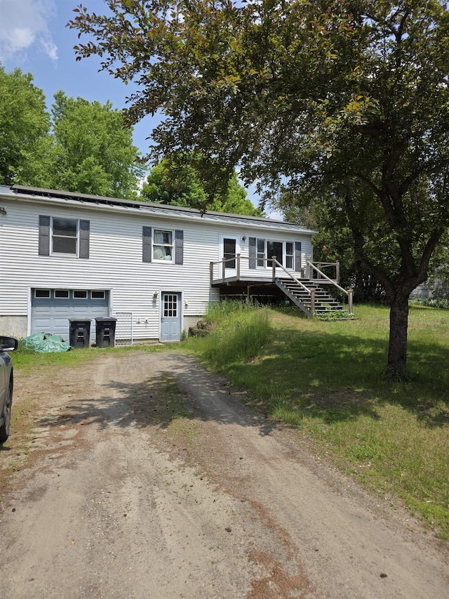 142 Sugar Plum Ct, Randolph, VT 05060 - view of front of home with dirt driveway, a garage, stairs, and a deck