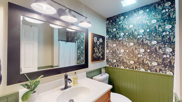 501 Bean Hill Rd Unit 32, Northfield, NH 03276 - bathroom with wainscoting, vanity, wallpapered walls, and curtained shower