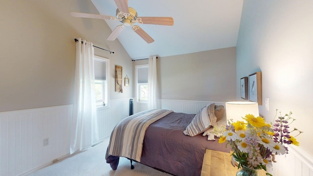 501 Bean Hill Rd Unit 32, Northfield, NH 03276 - carpeted bedroom featuring lofted ceiling, a wainscoted wall, and a ceiling fan