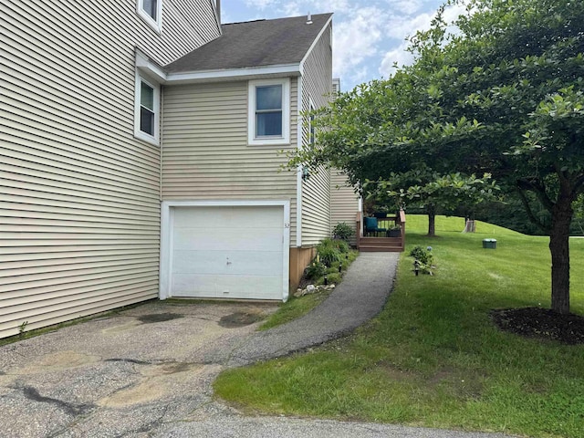 501 Bean Hill Rd Unit 32, Northfield, NH 03276 - view of side of property featuring a garage, a yard, a deck, and asphalt driveway